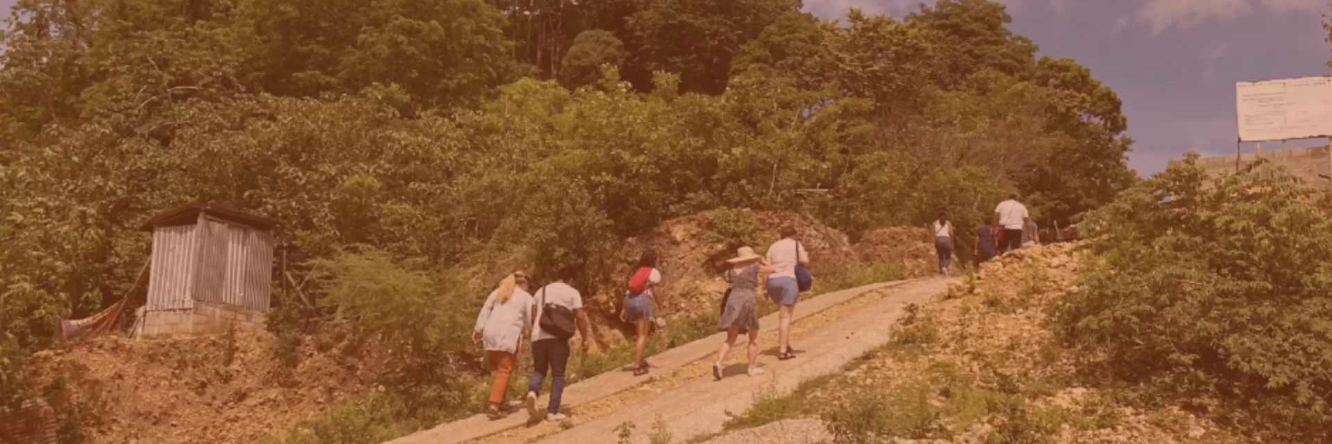 People hiking up a hill.