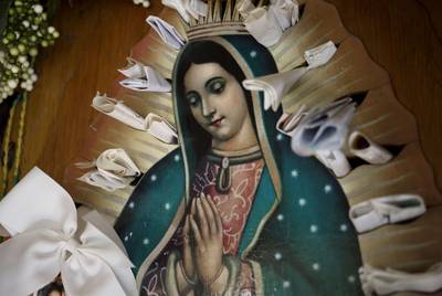 Parishioners and visitors at La Lomita leave notes of gratitude in a wooden image of La Virgen of Guadalupe. Many of these notes ask, or give thanks, for miracles.