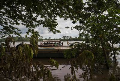 Migrants cross the Usumacinta River between La Técnica, Guatemala and Frontera Corozal, México on Oct. 21. The Usumacinta River acts as a border between the two countries. There is no immigration inspection in either of the two borders in the area.
