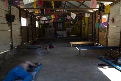 Honduran migrants Juan Ramón Andino, 60, left, and José, 40, right, sleep in a church that also serves as a migrant shelter in the community General Emiliano Zapata del Valle near Palenque, Chiapas on Oct. 24. The shelter is located along Highway 307 known as 